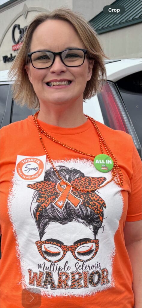 A photo of teacher suzy mullins wearing a tshirt from a walk to support MS research