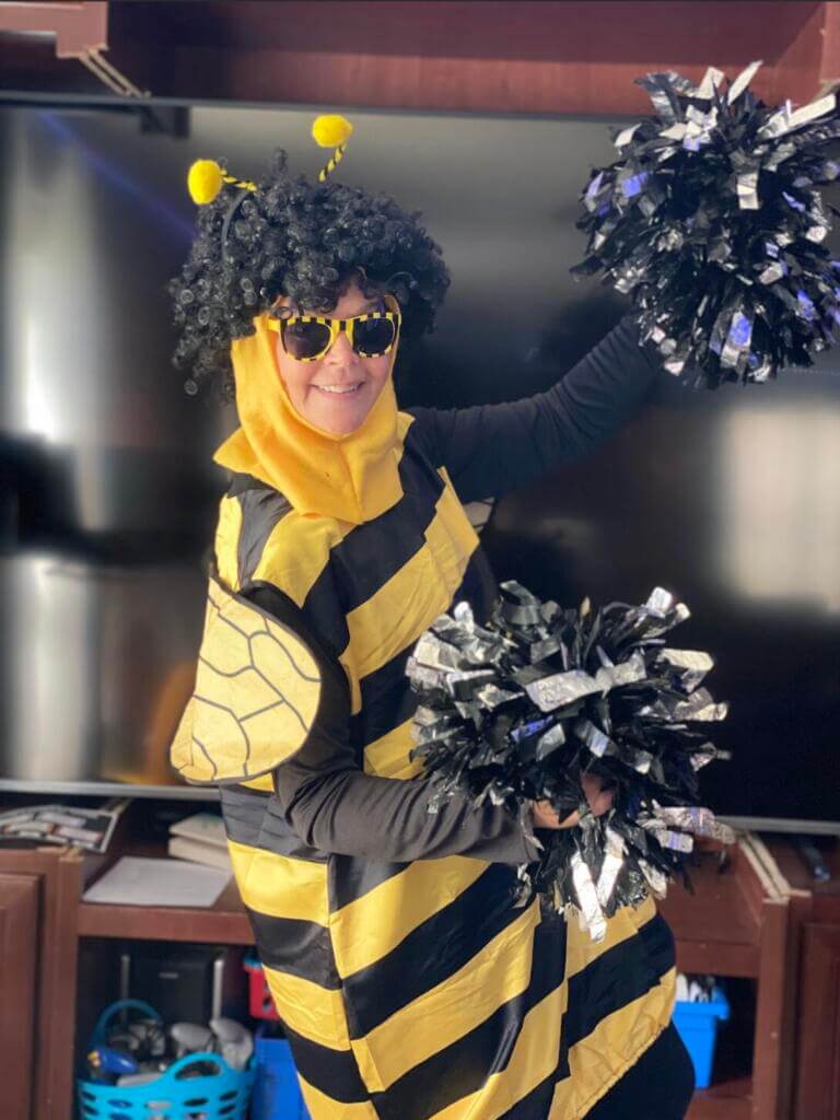 Ms. Osborne in a bee costume with pom poms
